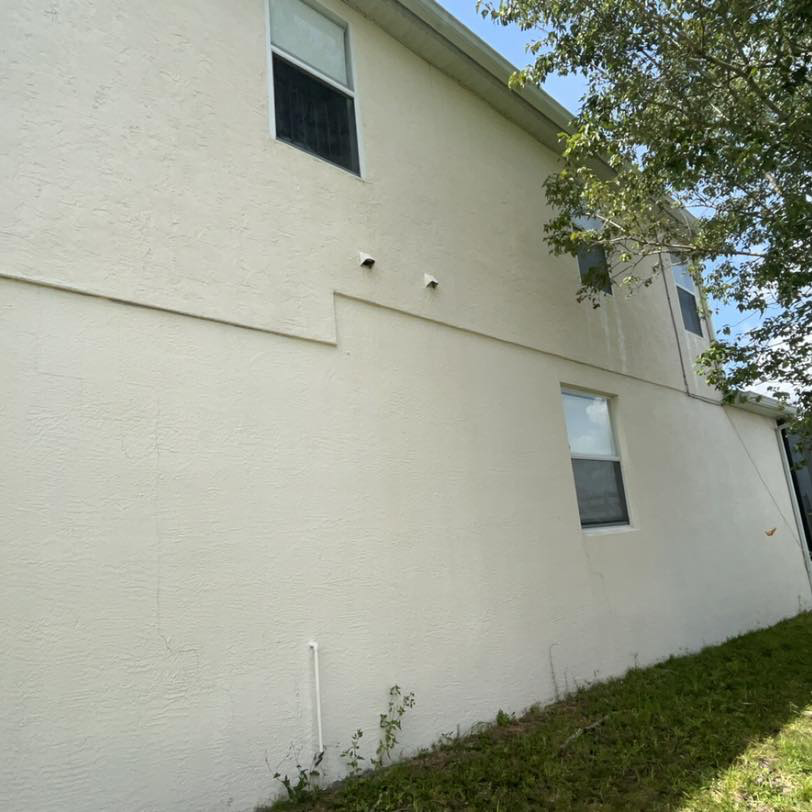 Stucco house wall after Jay's Pressure Washing soft wash